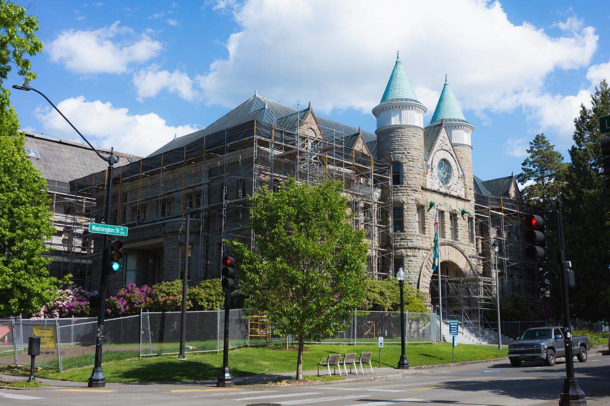 The sun beams onto the facade of the Old Capitol Building in downtown Olympia on Monday, May 18, 2026. The historic building has been surrounded by scaffolding and fencing for months as contractors replace the roof.