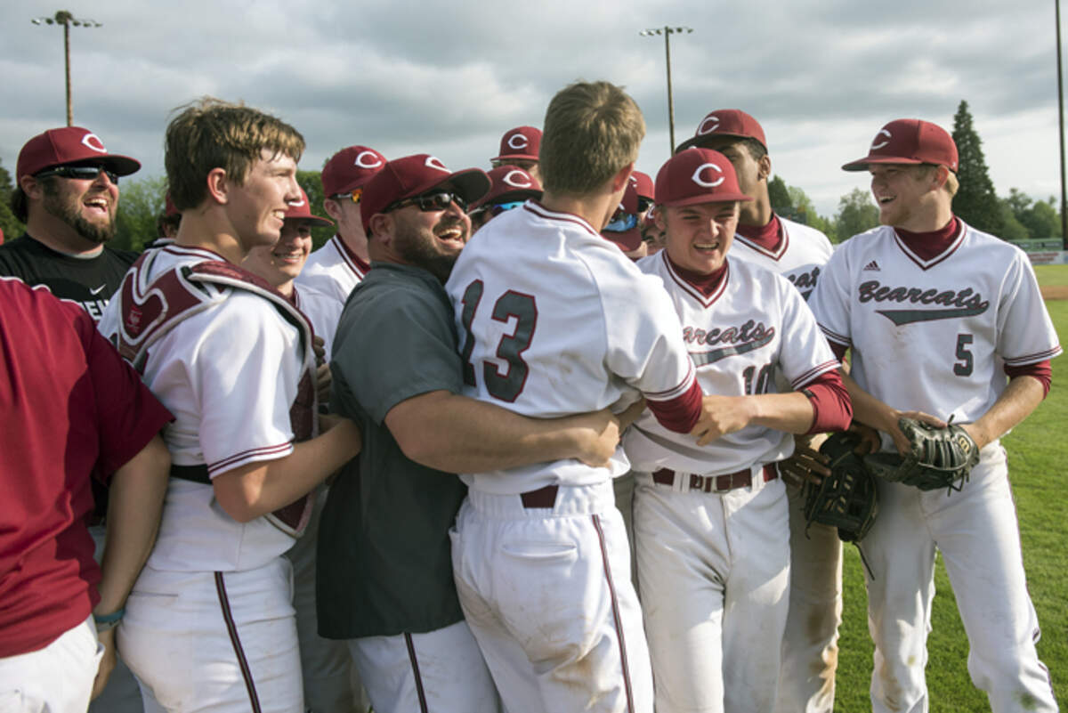 W.F. West players and coaches congratulate Brock Jones (13) after Jones struck out the final batter in a 2A state quarterfinals game against North Kitsap at Ed Wheeler Field in Centralia on Saturday, May 19, 2018.