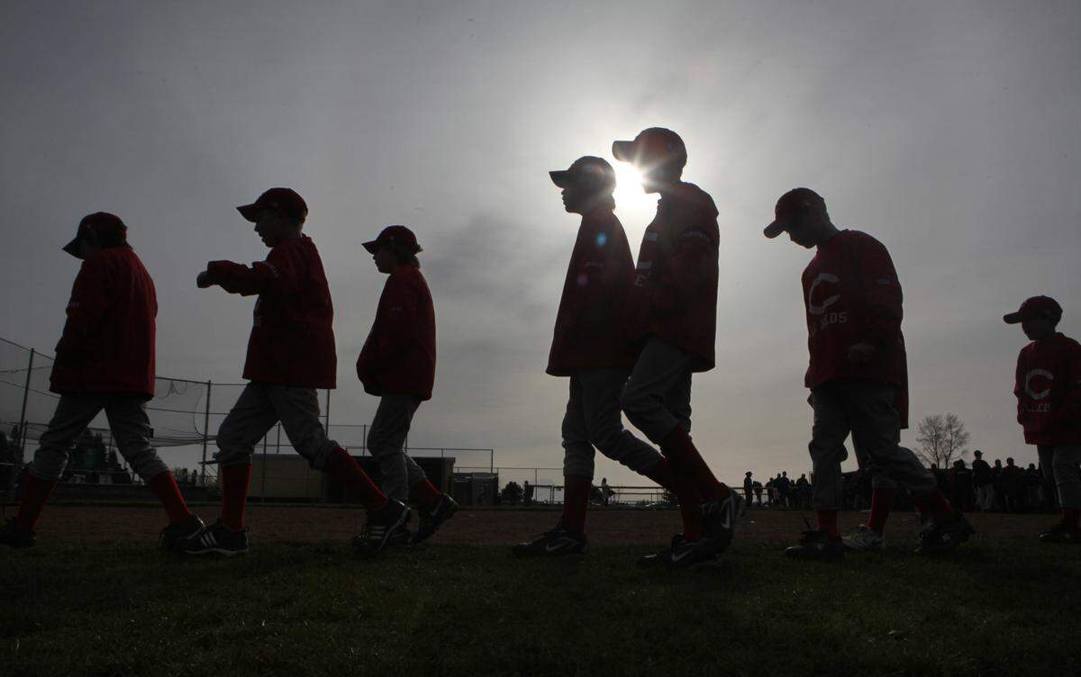 A Capitol Little League team heads to the baseball diamond for the season-opening ceremonies in Tumwater in 2010. The boys of summer returned to the fields this week, after COVID-19 threatened to cancel the 2020 little league season.