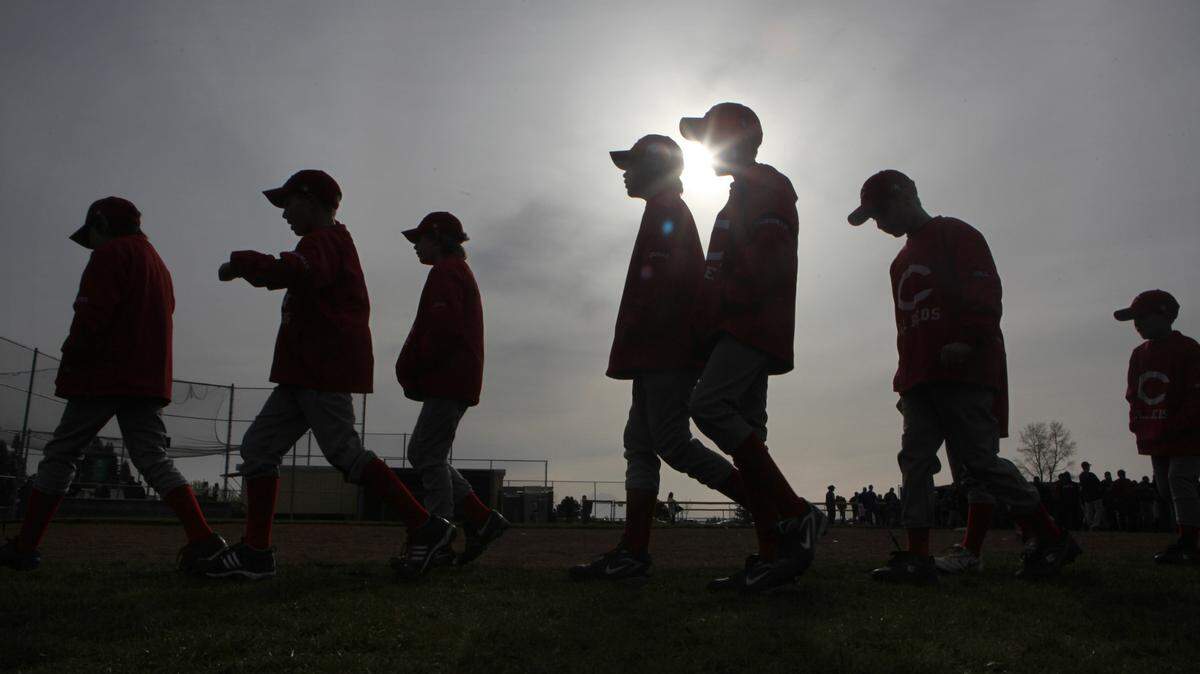 A Capitol Little League team heads to the baseball diamond for the season-opening ceremonies in Tumwater in 2010. The boys of summer returned to the fields this week, after COVID-19 threatened to cancel the 2020 little league season.