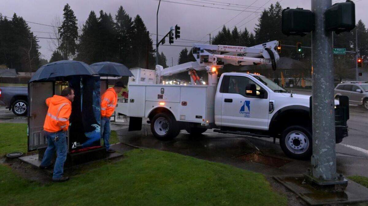 City of Olympia crews work to restore traffic lights at Wiggins Road and Yelm Highway after a windstorm blew through the area overnight Tuesday.