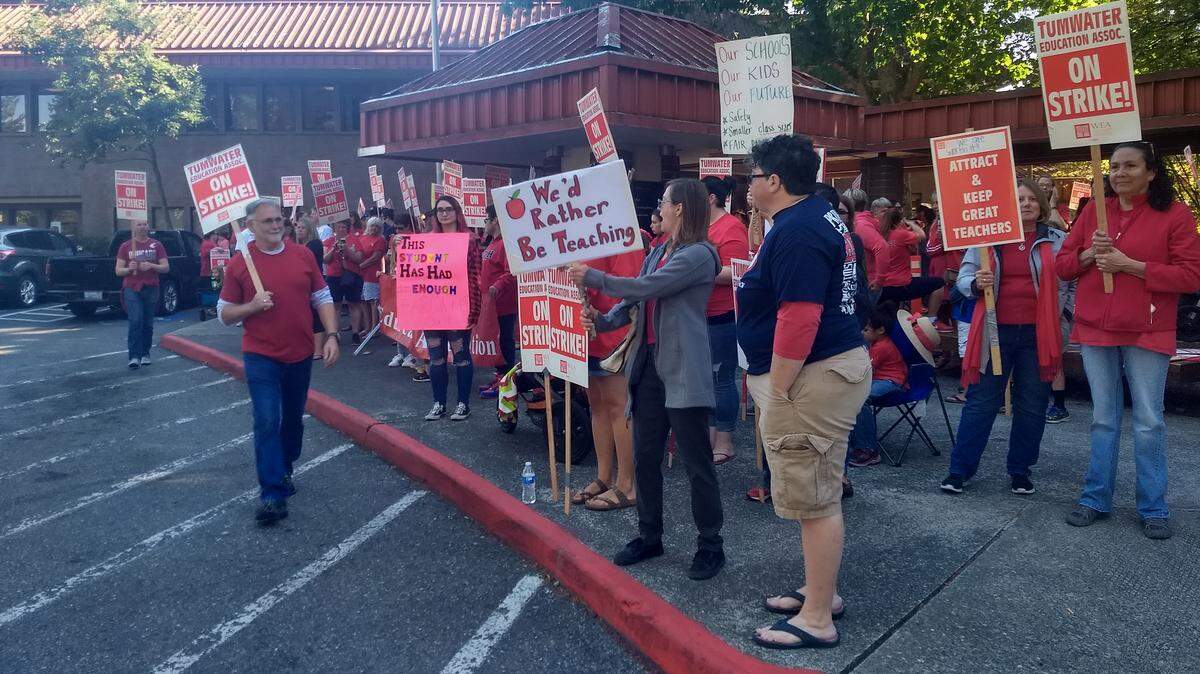 Tumwater teachers rally outside Thurston County Superior Court on Friday. Judge Chris Lanese ruled their ongoing strike is illegal but held off on ordering them back to work.
