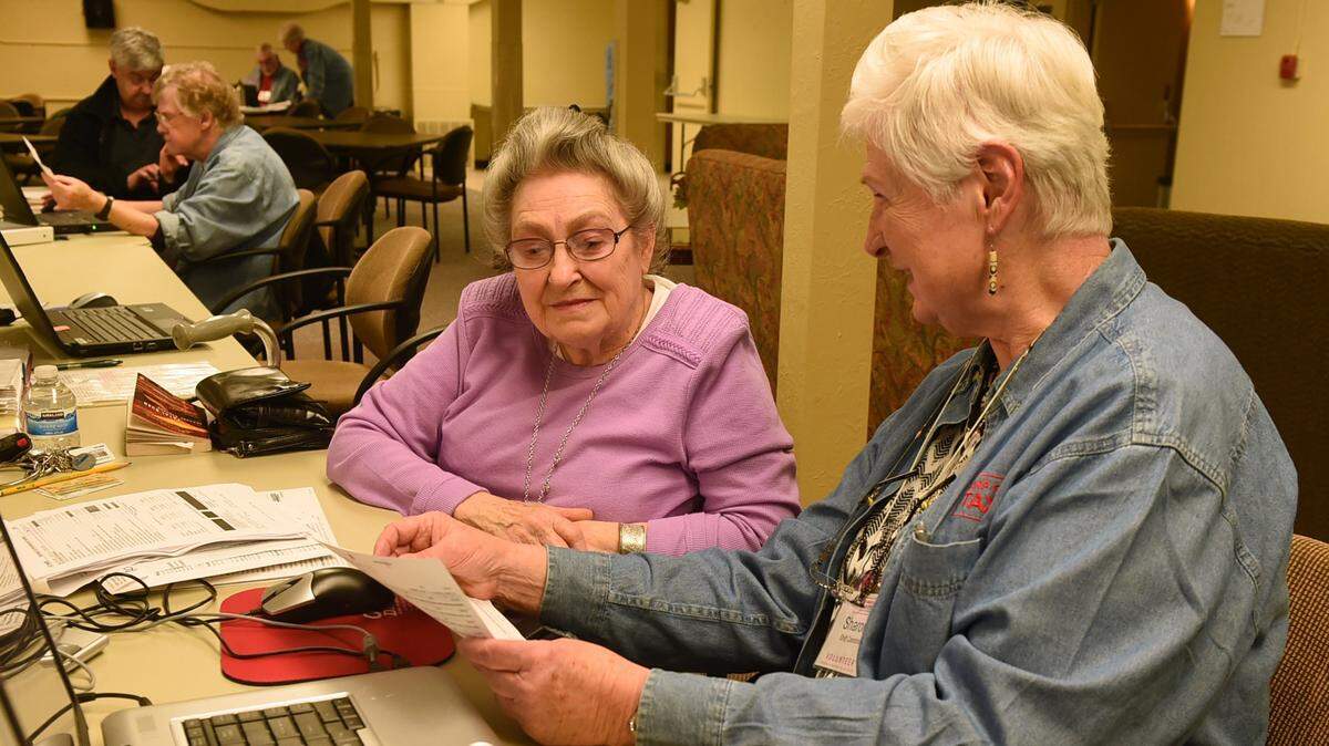 AARP volunteer Sharon Brown, right, helps Patricia Herigstad with her return during a 2016 tax assistance session at the Panorama Chalet in Lacey.