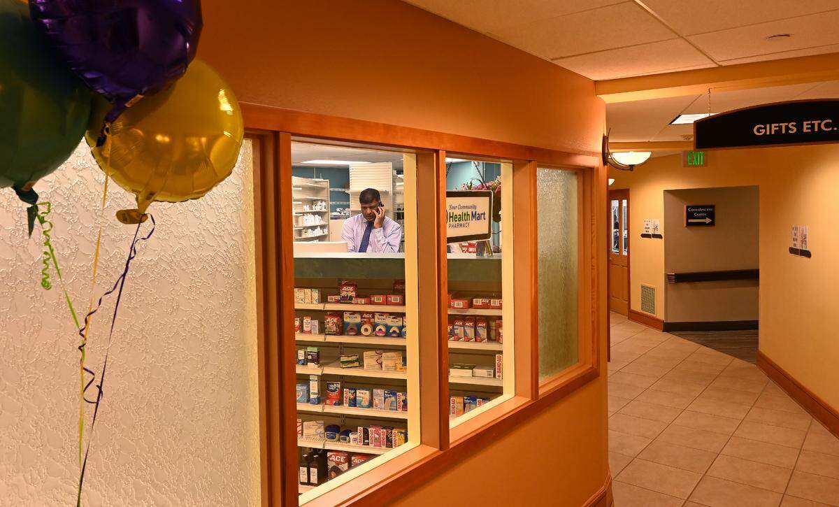 Hawks Prairie Pharmacy Health Mart owner Sunil Gowda celebrates the opening of his second location in Lacey at the Panorama retirement community with a noon ribbon cutting courtesy of the Thurston County Chamber of Commerce on Wednesday.