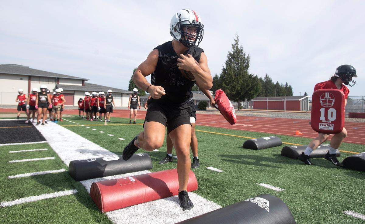 Yelm running back Brayden Platt runs through drills during the Tornados’ preseason football practice at Yelm High School in Yelm, Washington, on Thursday, Aug. 17, 2023.