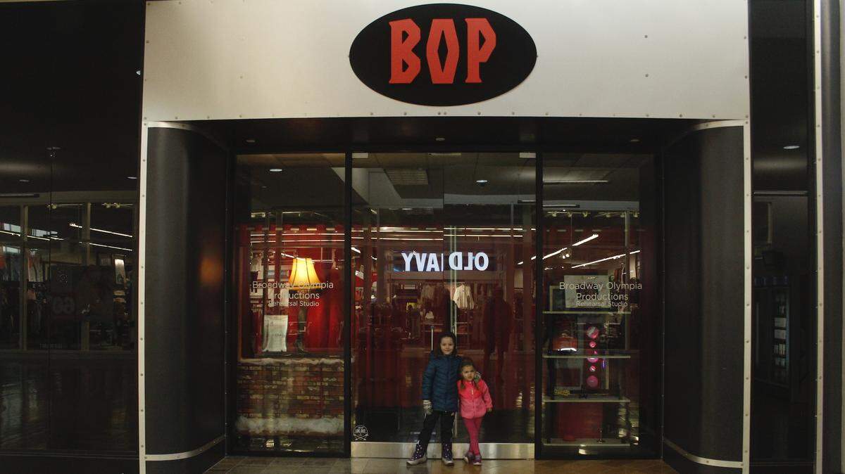 Hanna and Addie Murphy pose in front of the new Broadway Olympia studio, which is across from Old Navy at Capital Mall.