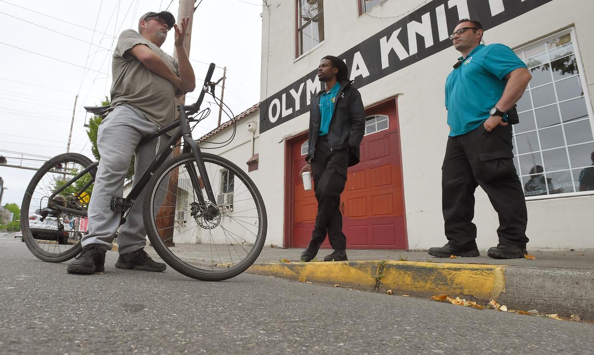 CRU’s Christopher Jones, center, and David Gervais chat with a client Wednesday.