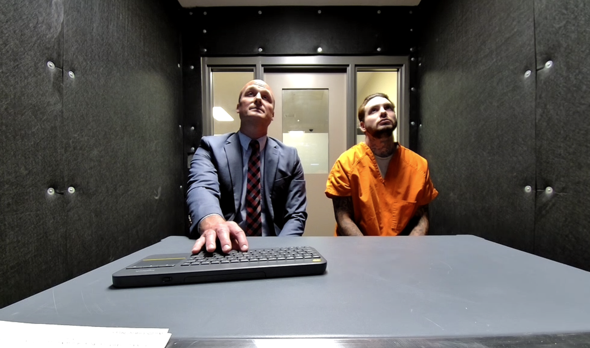 Damien Madison, 27, virtually attends his warrant identification hearing in Thurston County Superior Court from the county jail on Wednesday, June 11, 2025. He sits next to public defense attorney Brian Gerhart.
