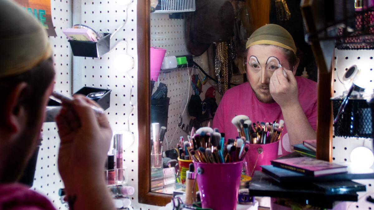Daniel, 31, sits in their Lacey garage and applies makeup to transform themselves into drag queen Alpha Awlknight. They have made a name for themselves over the past couple years, hosting dozens of shows and performances highlighting other drag artists in the region.