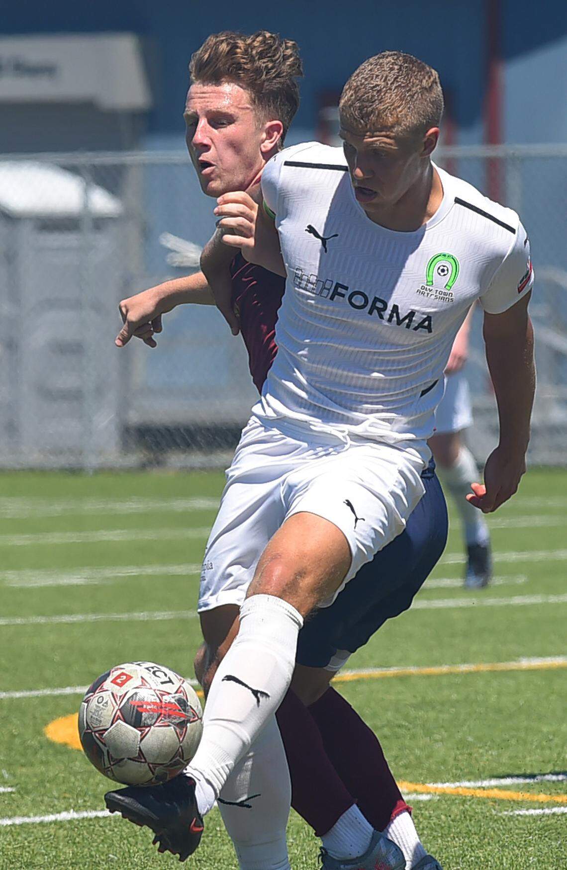 Oly Town Artesians FC midfielder Alec Zimmerman battles for control against OFV Alliance midfielder Anders Lebate during their Sunday, June, 26, 2022 match at Black Hills High School. Zimmerman scored the home team’s last gaol in the second half for the team’s 6-5 win.