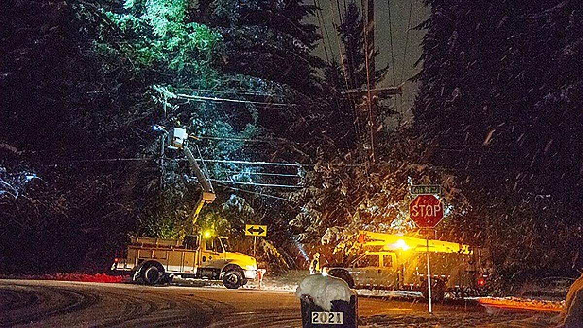 PSE crew members respond to a power outage along Cain Road in Olympia in February 2019.