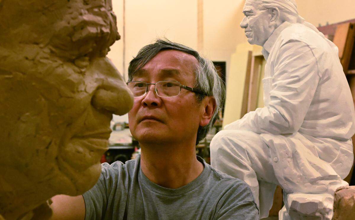 Working in the stage room of the Minnaert Center for the Arts at South Puget Sound Community College on June 7, 2024 Seattle artist Haiying Wu continues his sculpting of the Billy Frank Jr. statue destined for the National Statuary Hall.