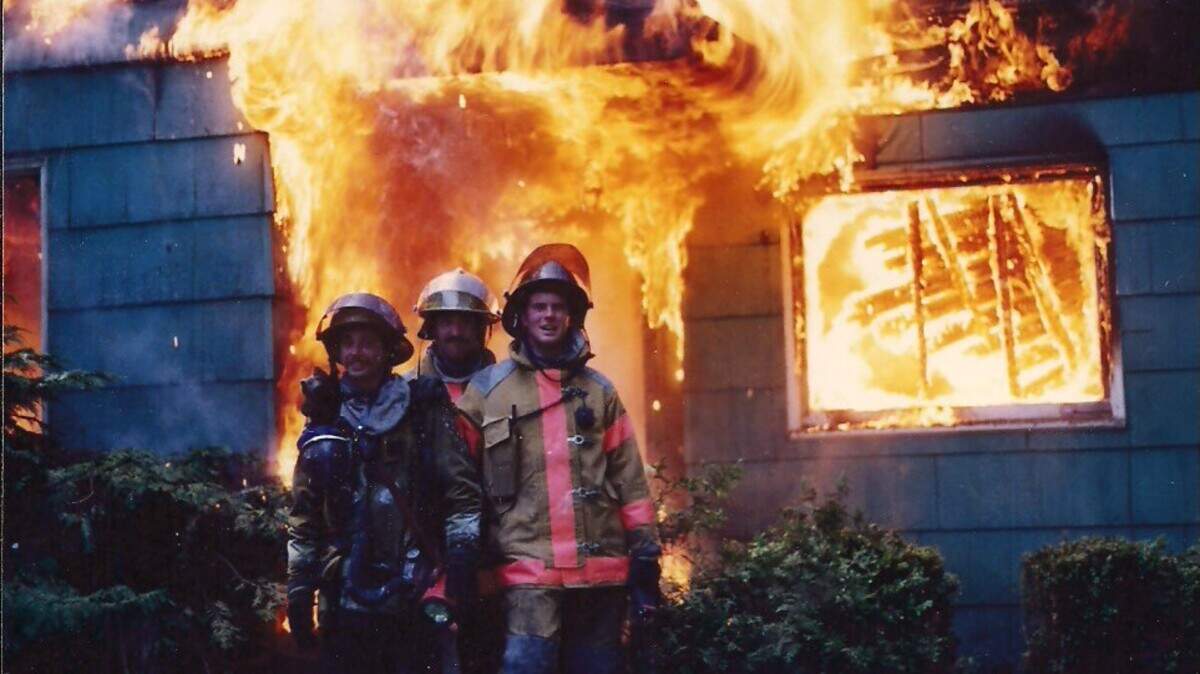 Student firefighters pose outside a burning building in “Station 93,” about The Evergreen State College’s student firefighting program in the 1970s.