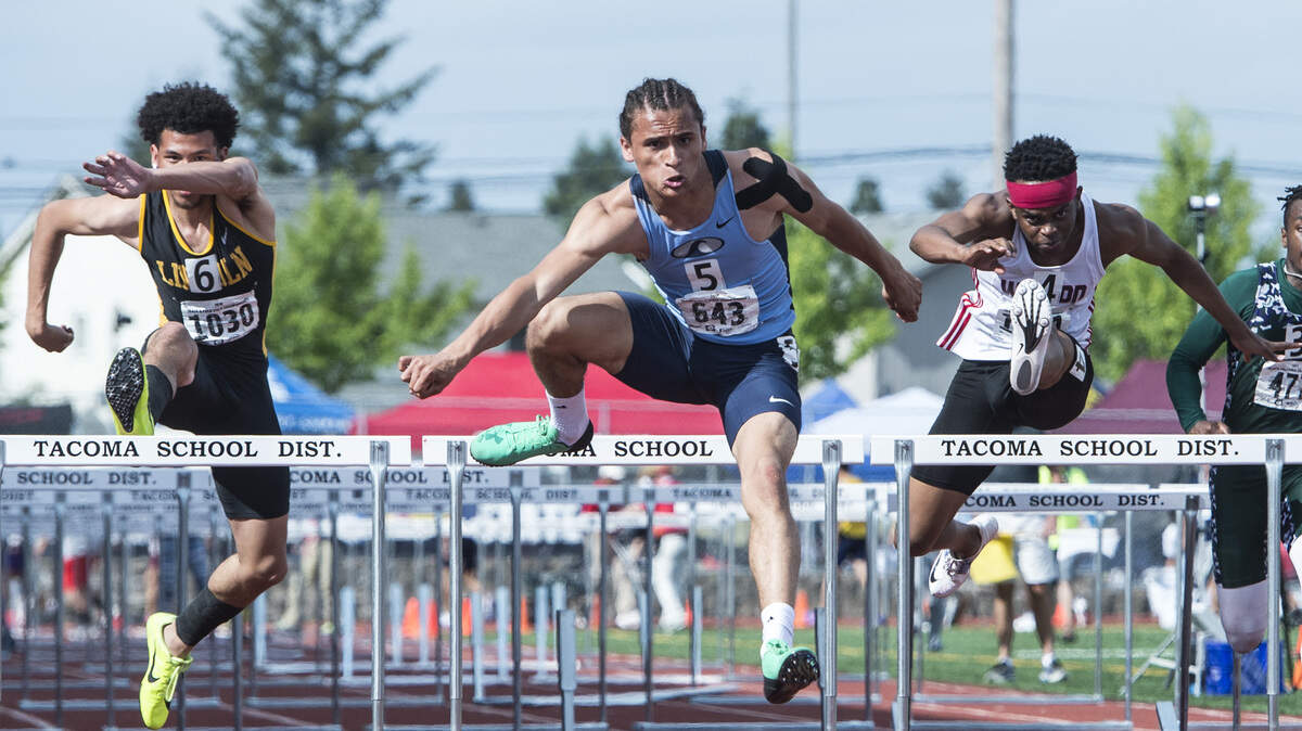 Gig Harbor’s Jurrian Hering (643) leads the 3A boys 110-meter hurdles final with Wilson’s David Njeri and Lincoln’s Marcus Williams Jr. in pursuit at the 4A/3A/2A track and field state championships at Mount Tahoma High School in Tacoma on Friday, May 25, 2018.