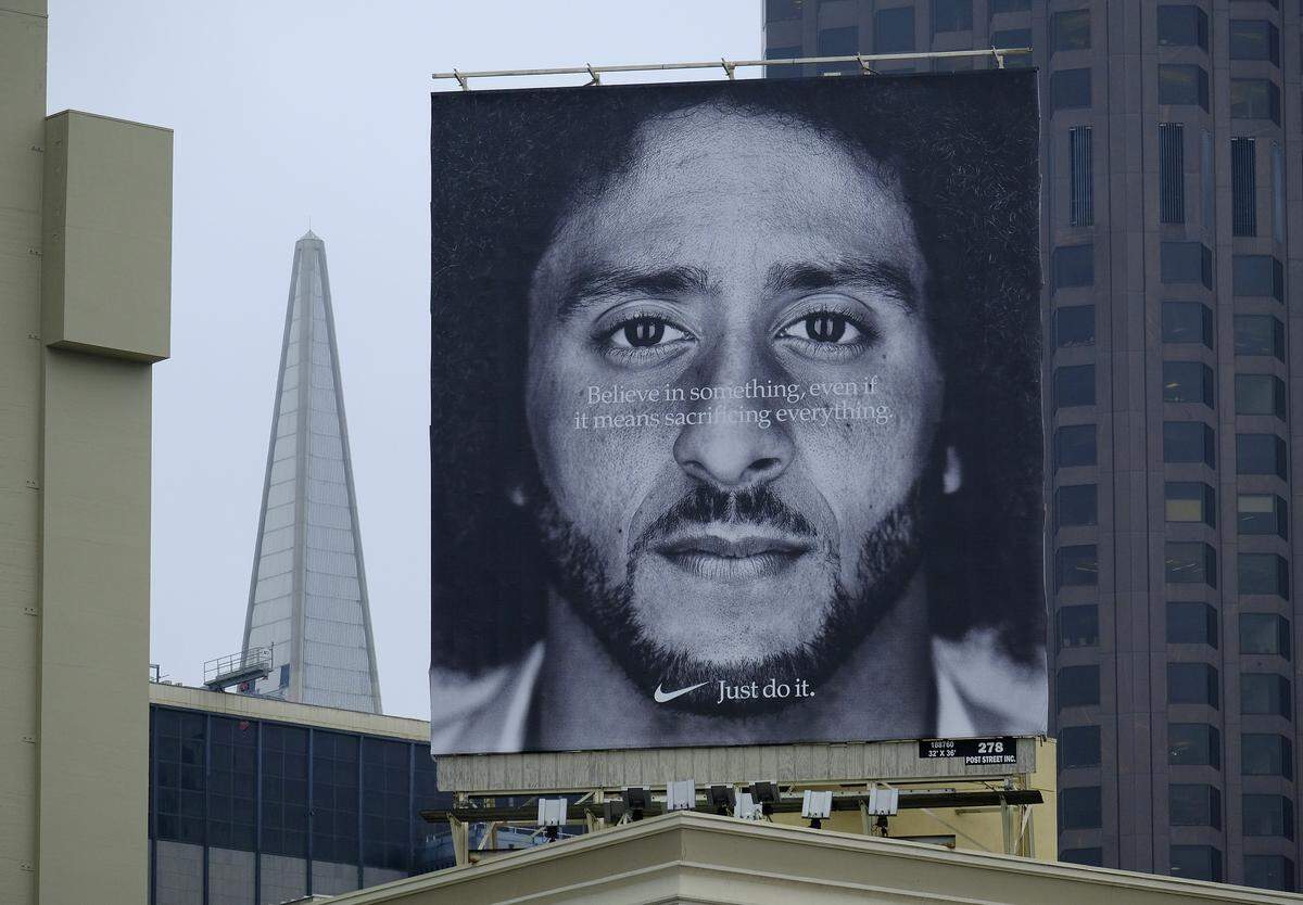 A large billboard stands on top of a Nike store showing former San Francisco 49ers quarterback Colin Kaepernick at Union Square, in San Francisco. An endorsement deal between Nike and Colin Kaepernick prompted a flood of debate as sports fans reacted to the apparel giant backing an athlete known mainly for starting a wave of protests among NFL players of police brutality, racial inequality and other social issues.