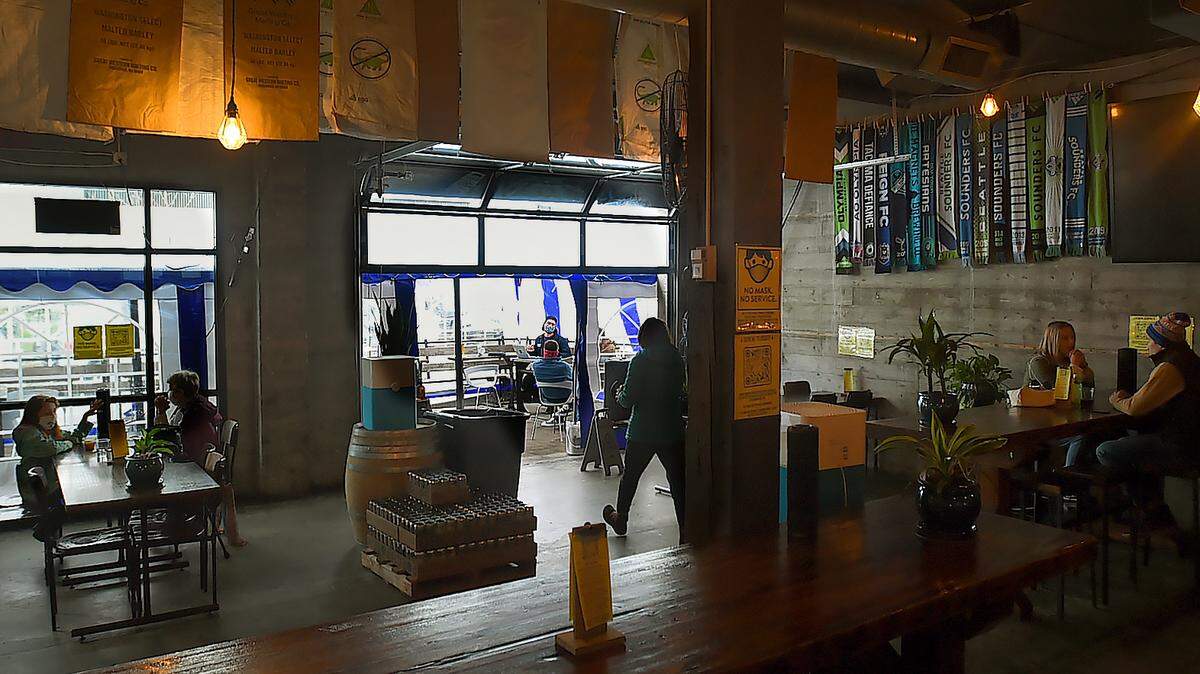 Patrons can once again enjoy either inside or outside dining at Three Magnets Brewing Company in Olympia. It set up a covered outdoor dining area in Phase 1, and is keeping its garage-style door open to keep the inside ventilated.