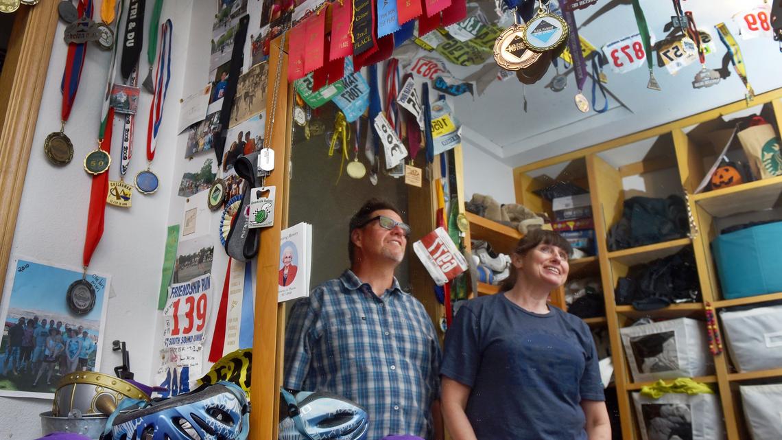 Surrounded by marathon memories in a closet at their Tumwater home, Bill and Tammy Herzog share stories of close friends Andy and Jody Fritz. The couple was well-known in the running community and active with the Capital City Marathon. They died in bus crash in Mexico in December.