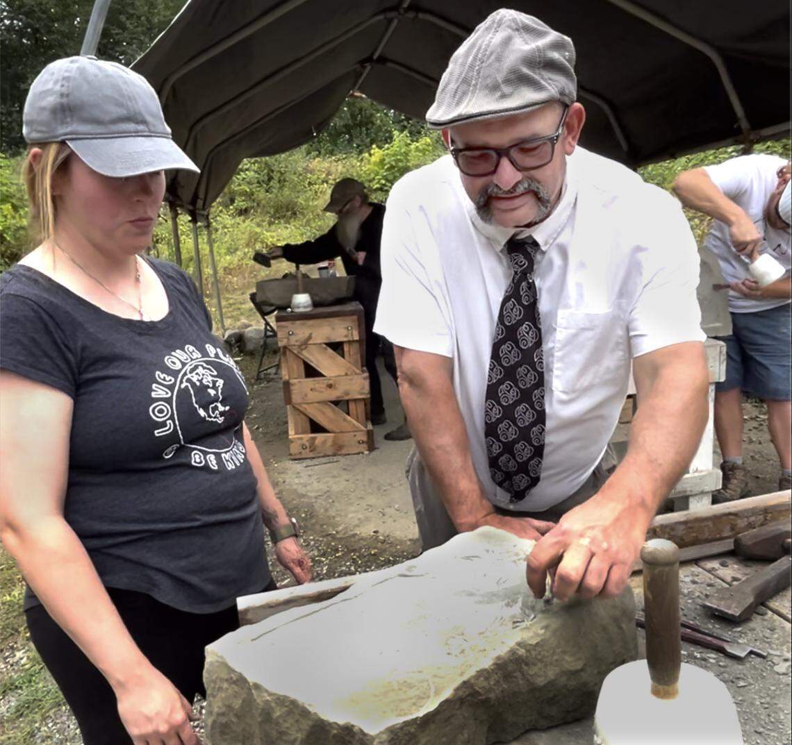 Working at the Hercules #1 Quarry in Tenino on Aug. 16, student Lindsay Taylor and instructor Dan Miller go over her project featuring an image of a dragon on a piece of stone. The work was part of a carving class series offered by the Tenino Stone Carvers Guild. Held on three Saturdays in August, guild instructors Miller and Myrna Orsini led two distinctly different classes: “Intro to Banker Masonry" with Miller and Hammer & Chisel Carving” with Orsini.