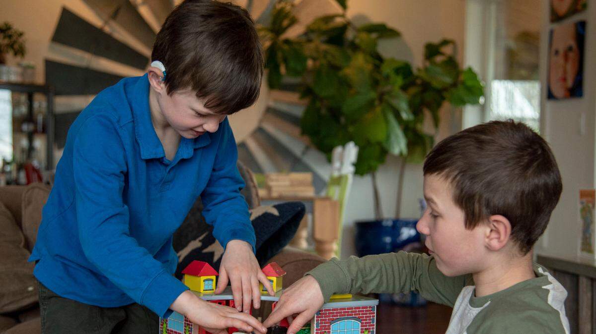 Hugo Bujnevicie and his brother Enzo play together at their home in Normandy Park. Their mother, Jill Bujnevicie testified for a bill that would provide coverage for hearing aid instruments on behalf of Hugo, who was born with bilateral sensorineural hearing loss.