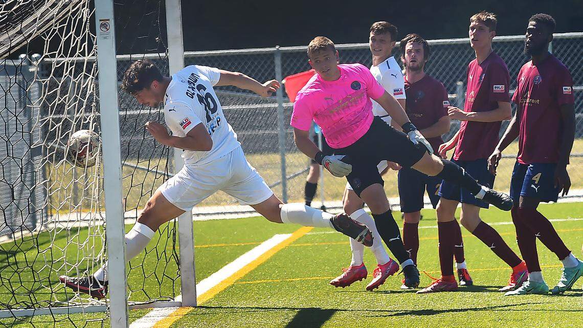 Oly Town Artesian FC’s Jose Marquez follows’ teammate Alec Zimmerman’s goal kick into the net against OFV Alliance in the second half of their Sunday match at Black Hills High School. That score made it 6-3, with the host team winning, 6-5.