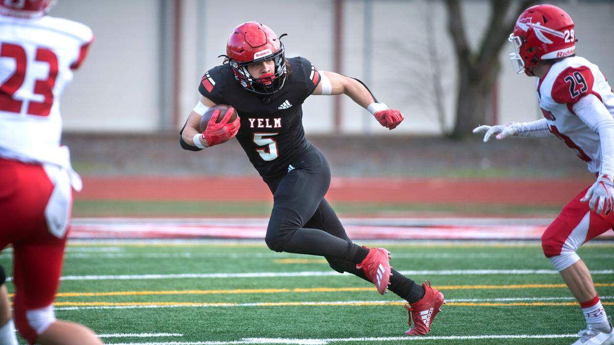 Yelm wide receiver Kyler Ronquillo tries to elude Marysville-Pilchuck defensive back Carson Kuchera during Saturday afternoon’s 3A football state quarterfinal game at Yelm High School in Yelm, Washington, on Nov. 20, 2021. Marysville-Pilchuck won the game, 39-21.