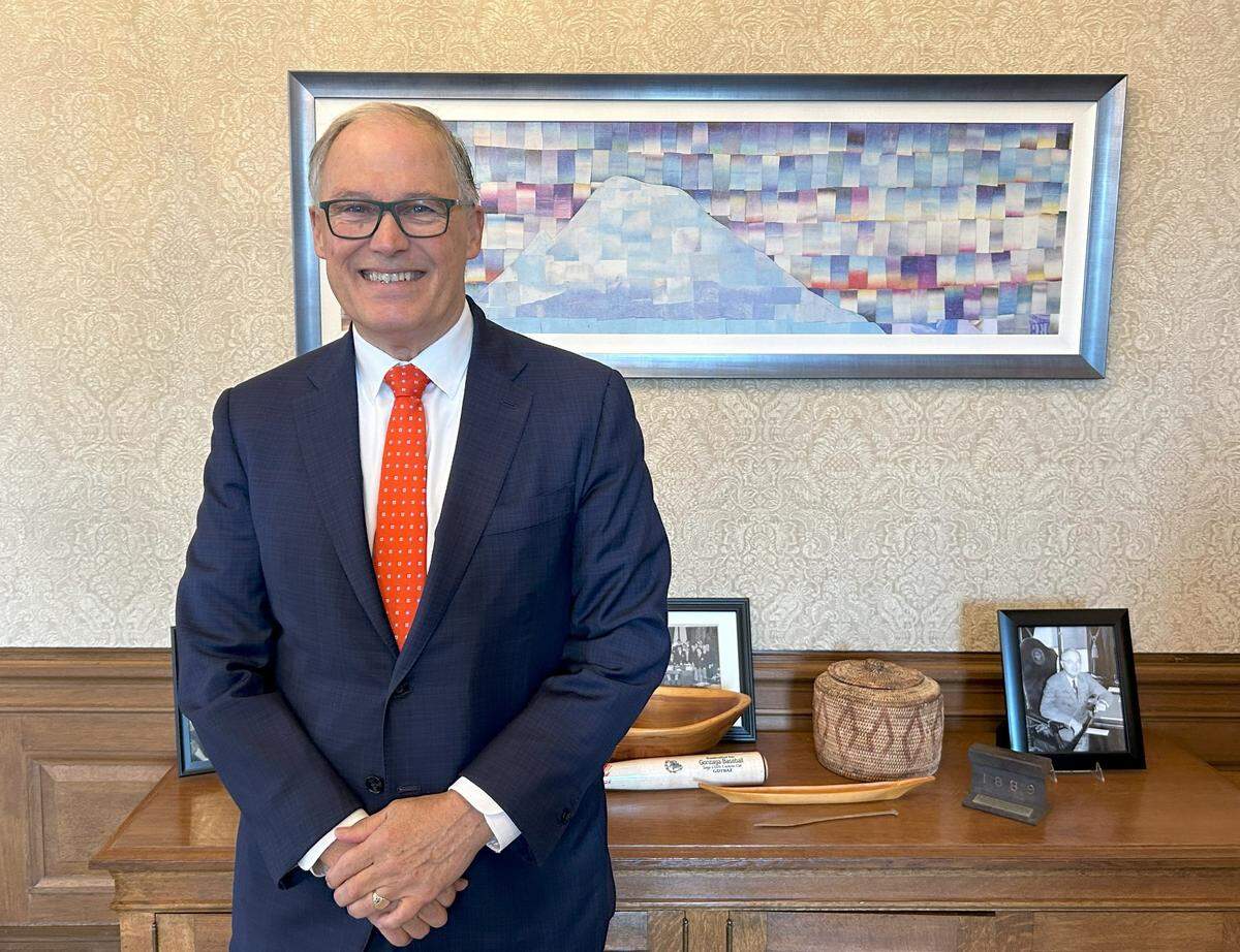 Gov. Jay Inslee poses for a photo in the Governor’s Office on Thursday, Dec. 19, 2024.