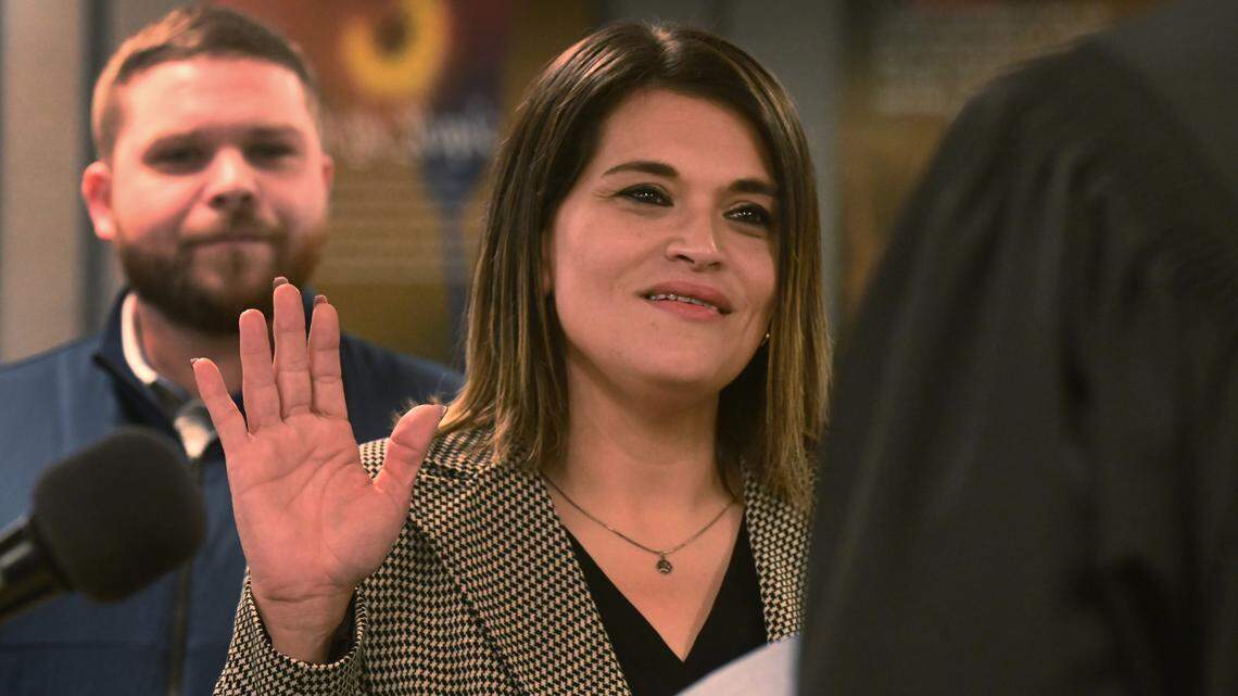 Joined at the podium by her husband Jeff, newly elected Thurston County Commissioner Rachel Grant is sworn in by Superior Court Judge Chris Lanese the Dec 17 ceremony at the Atrium building in Olympia which houses county services.