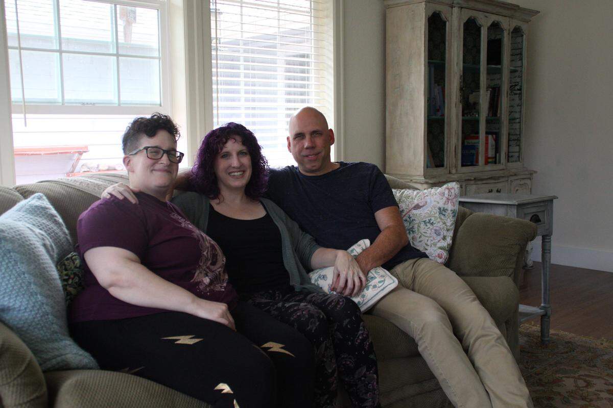From left: Ari Sobelman, Meredith Efken and Jason Efken in their home in west Olympia.