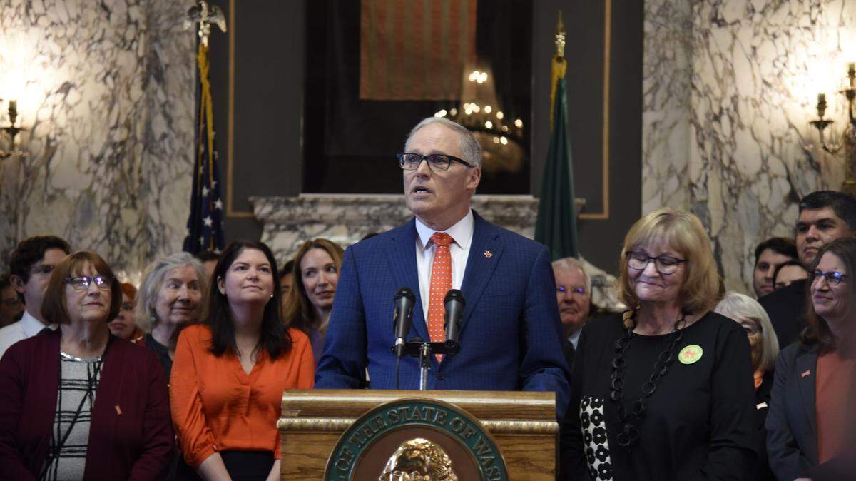 Gov. Jay Inslee speaks Tuesday before signing into law a bill banning assault weapons. Three gun-control bills were signed during the ceremony.