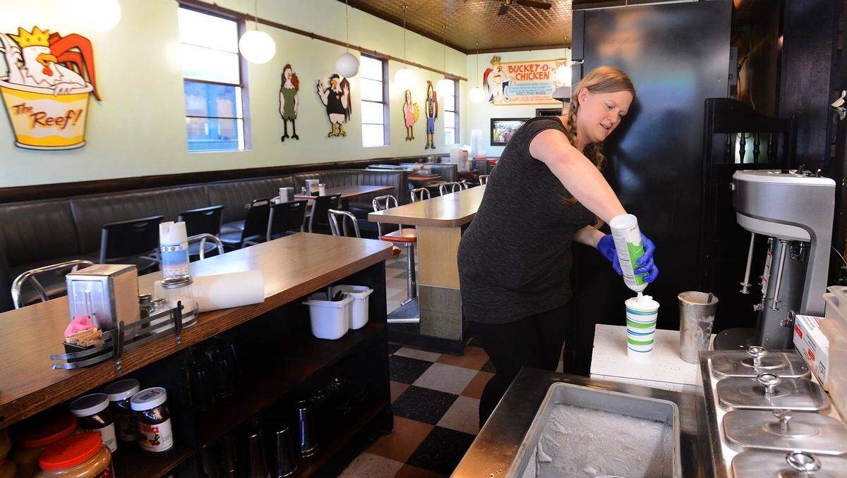 On the first day of their COVID-19 era food pick-up service April 6, 2020, King Solomon’s Reef Cafe and Lounge owner Lindy McIntyre finishes a mike shake order for an 18 year-old’s birthday celebration.