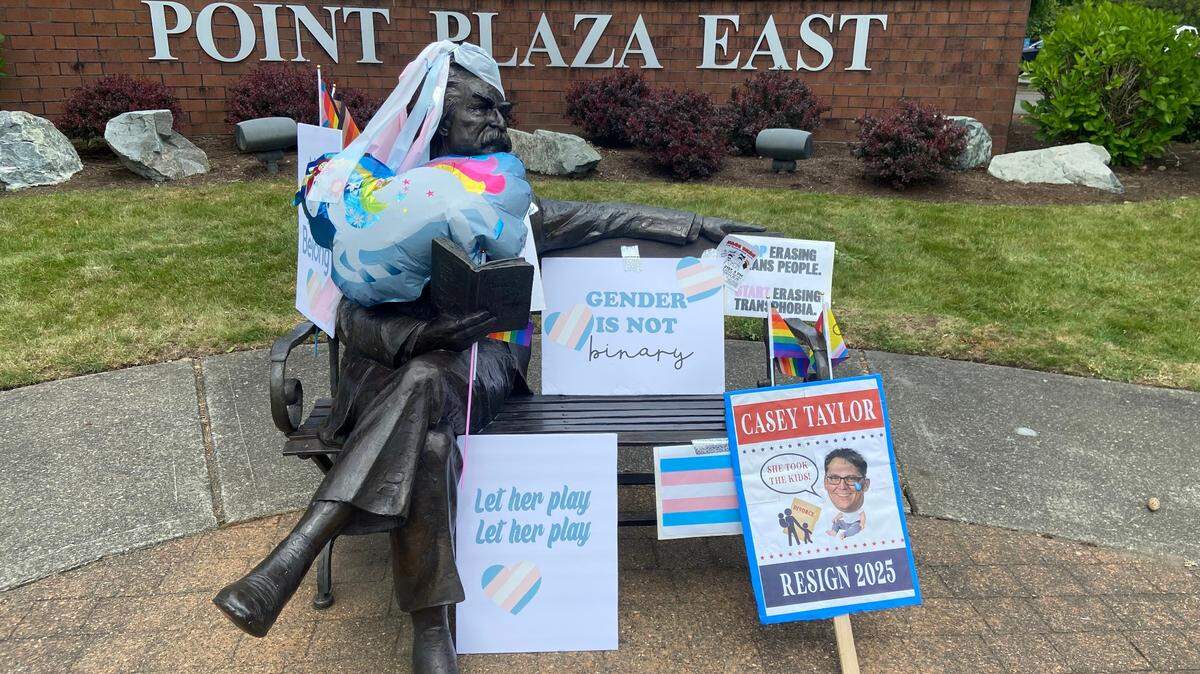 Tumwater School District students who participated in a walkout on May 21 in support of trans students’ rights decorated the Mark Twain statue down the street from Tumwater High School with flags and signs.