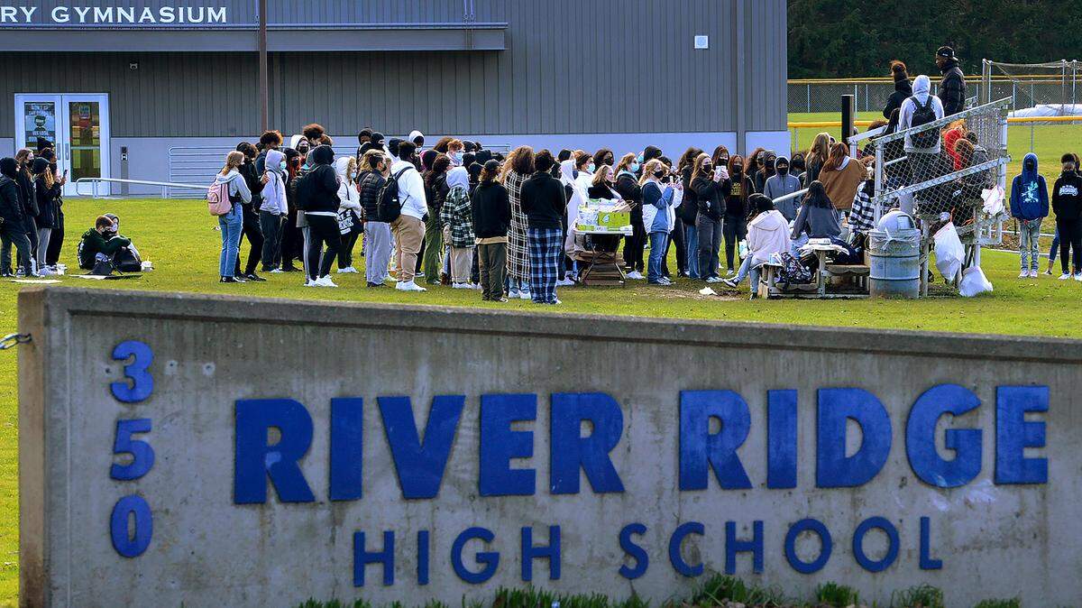 Students gather on the River Ridge High School practice soccer field for a noon rally on Monday, Jan. 31, 2022. A similar walkout also occurred at North Thurston High School.
