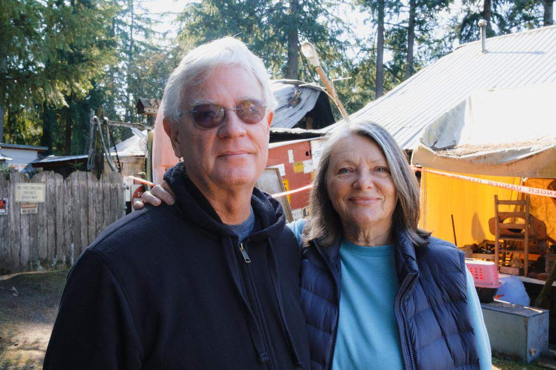 Terry Torrence, 73, (left) poses with his wife Lynn Middleton Torrence, 72, (right) outside The Second Hand Rose antique store on Monday, March 2, 2026. Torrence opened the store in 1984 and closed it in 2025 to retire.