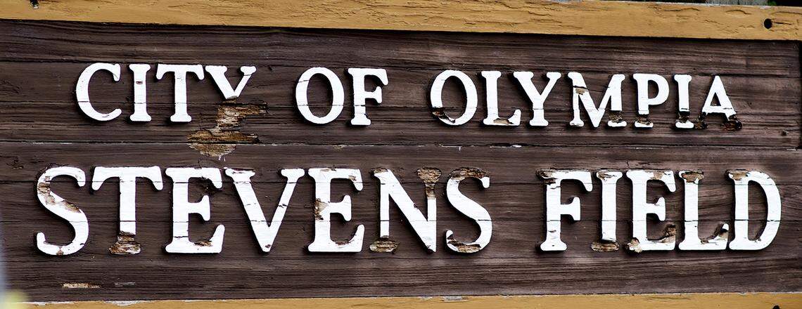 A brown sign with white text reads, "City of Olympia Stevens Field"