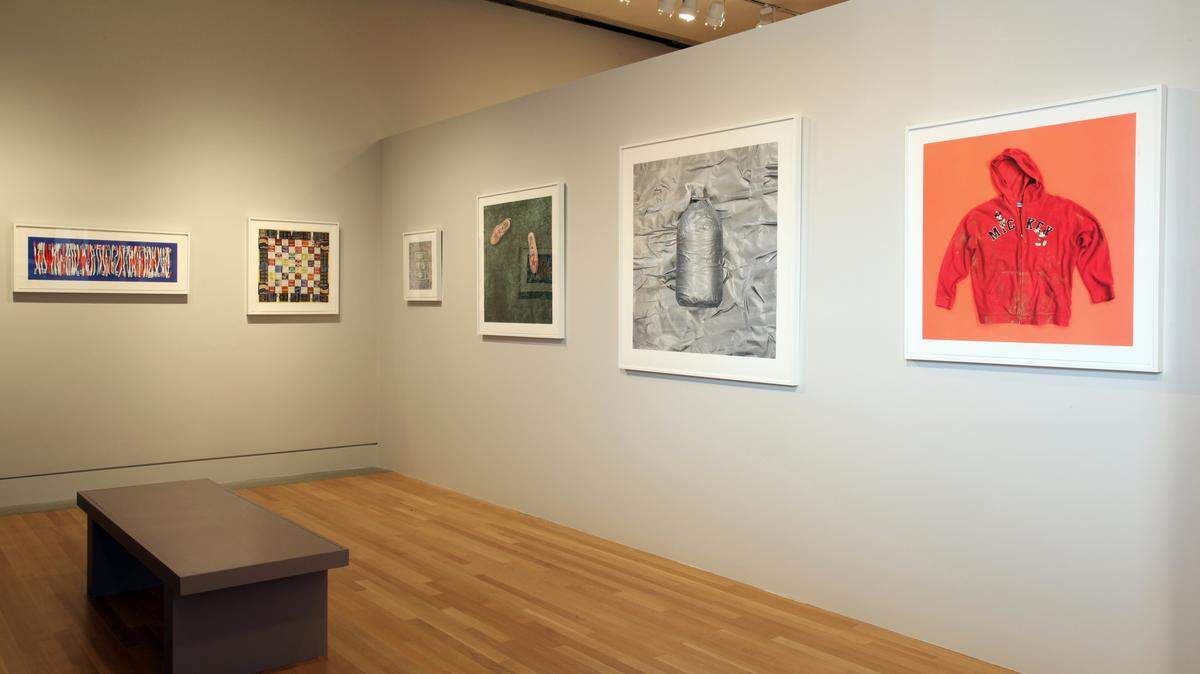 Tom Kiefer’s photos of objects taken from migrants by the Border Patrol hang in Los Angeles’ Skirball Cultural Center. Possessions considered non-essential or potentially dangerous — including water bottles and extra clothing — are confiscated.