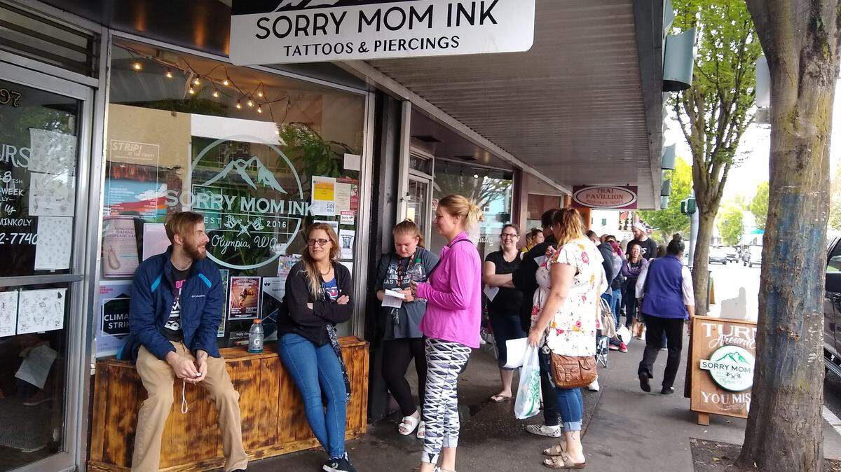 Dozens of people wait outside Sorry Mom Ink for its Friday the 13th special. People started lining up at 7 a.m. for tattoos starting at $13.
