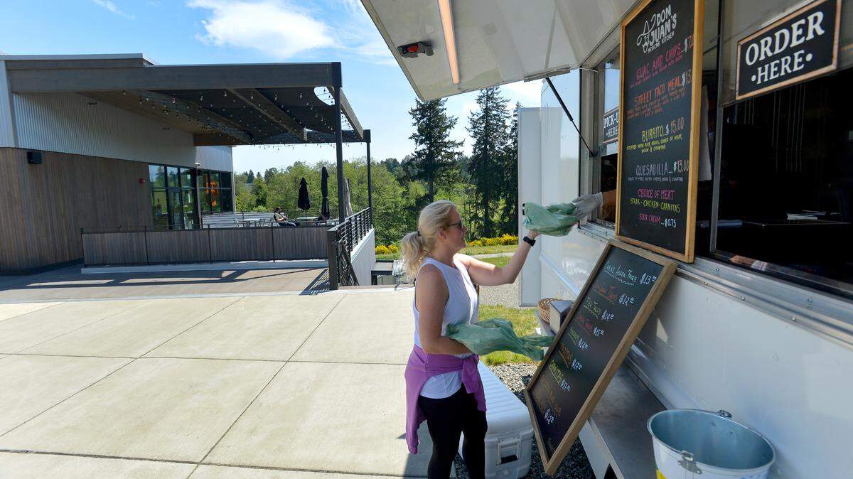 Familiar with the popular Tenino restaurant Don Juan’s Mexican Kitchen, Casey Rowe picks up Thursday lunch from their food truck at Tumwater’s Craft District on Capitol Boulevard.