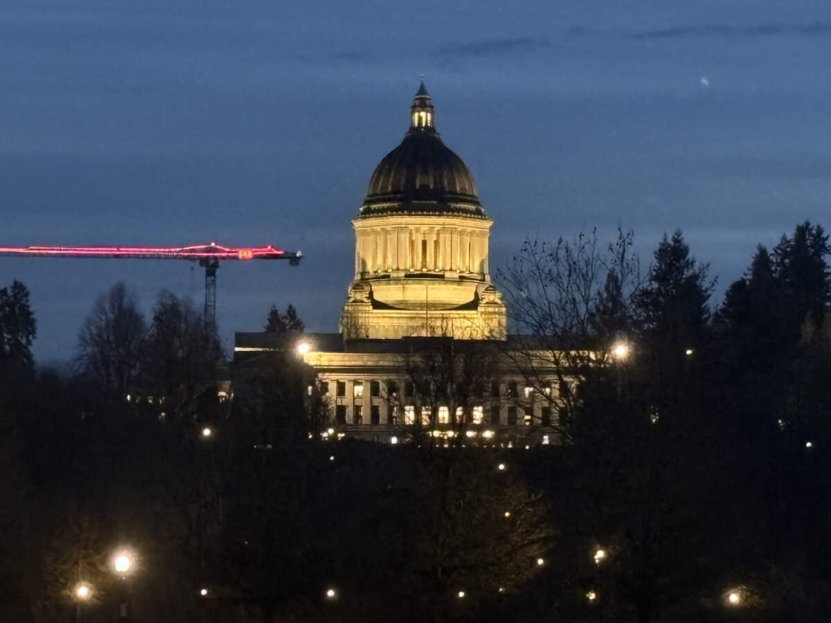 The Washington state Capitol building in Olympia is illuminated against a dark sky.