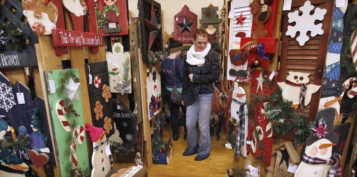 Nathanyel Fennell (facing) and friend Alyssha Neely look over wooden cut-outs during the 2014 Holiday Bazaar at the Thurston County Fairgrounds in Lacey.