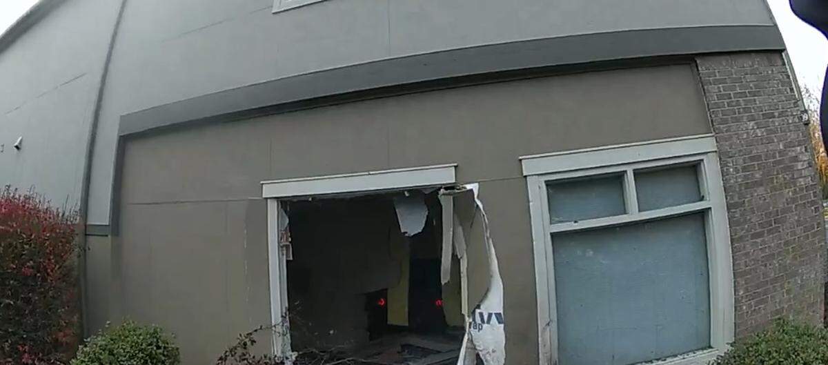 A two-car crash on Sunday sent a vehicle into a building in the 3000 block of Pacific Avenue Southeast. What appear to be red dots inside the building are the vehicle’s taillights.