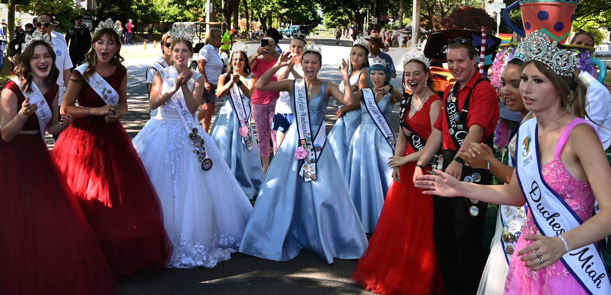 As temperatures nudged the 90-degree mark for the second year in a row at the 2024 Capital Lakefair Grand Parade, the hometown royal court (center) staged a quick, pre-parade dance party with visiting royalty before traveling north down Capitol Way.