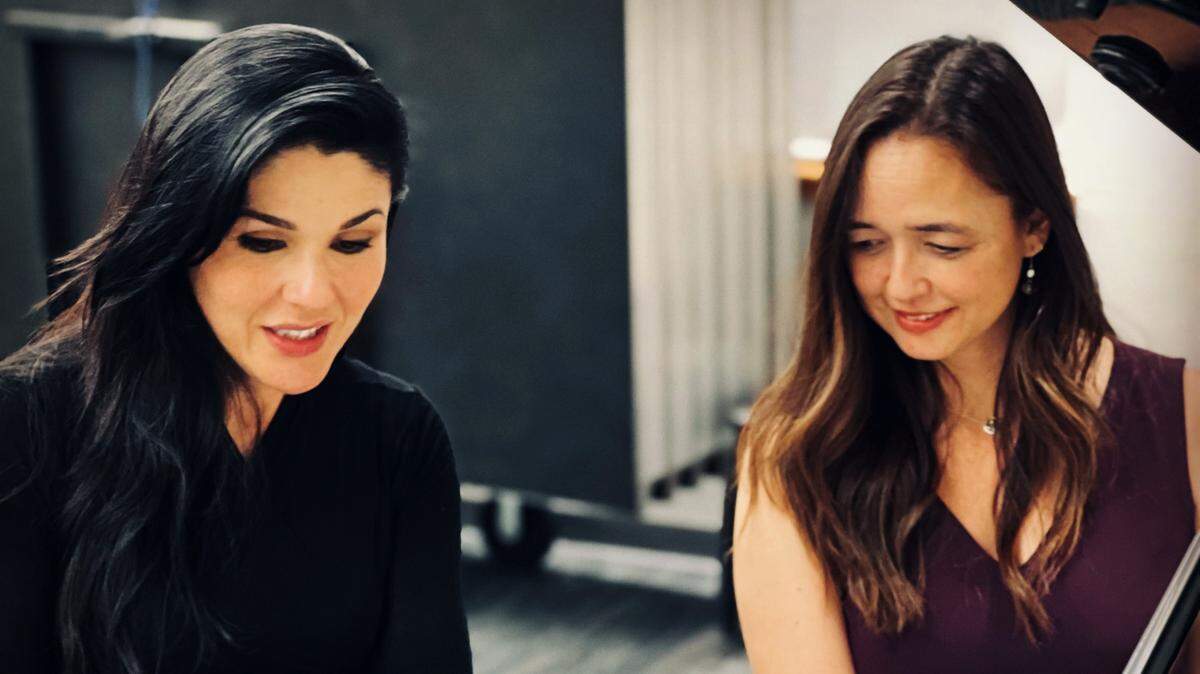 Olympia Symphony Orchestra music director Alexandra Arrieche (left) rehearses with executive director Jennifer Hermann, who’ll be the featured soloist at Sunday’s season reveal concert.