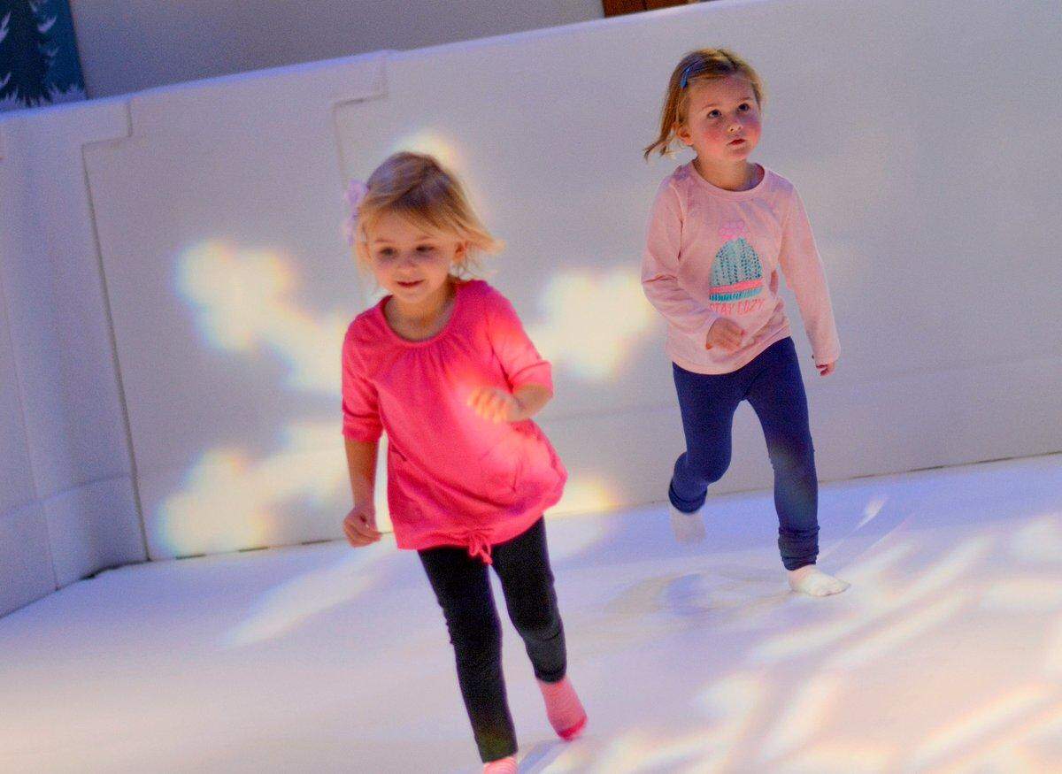 KIds enjoy “ice” skating in socks at the Boston Children’s Museum. Olympia’s Hands On Children’s Museum has purchased the floor tiles needed to build a similar 15-foot-by-30-foot rink made up of the same synthetic ice that ice skaters use for practice.