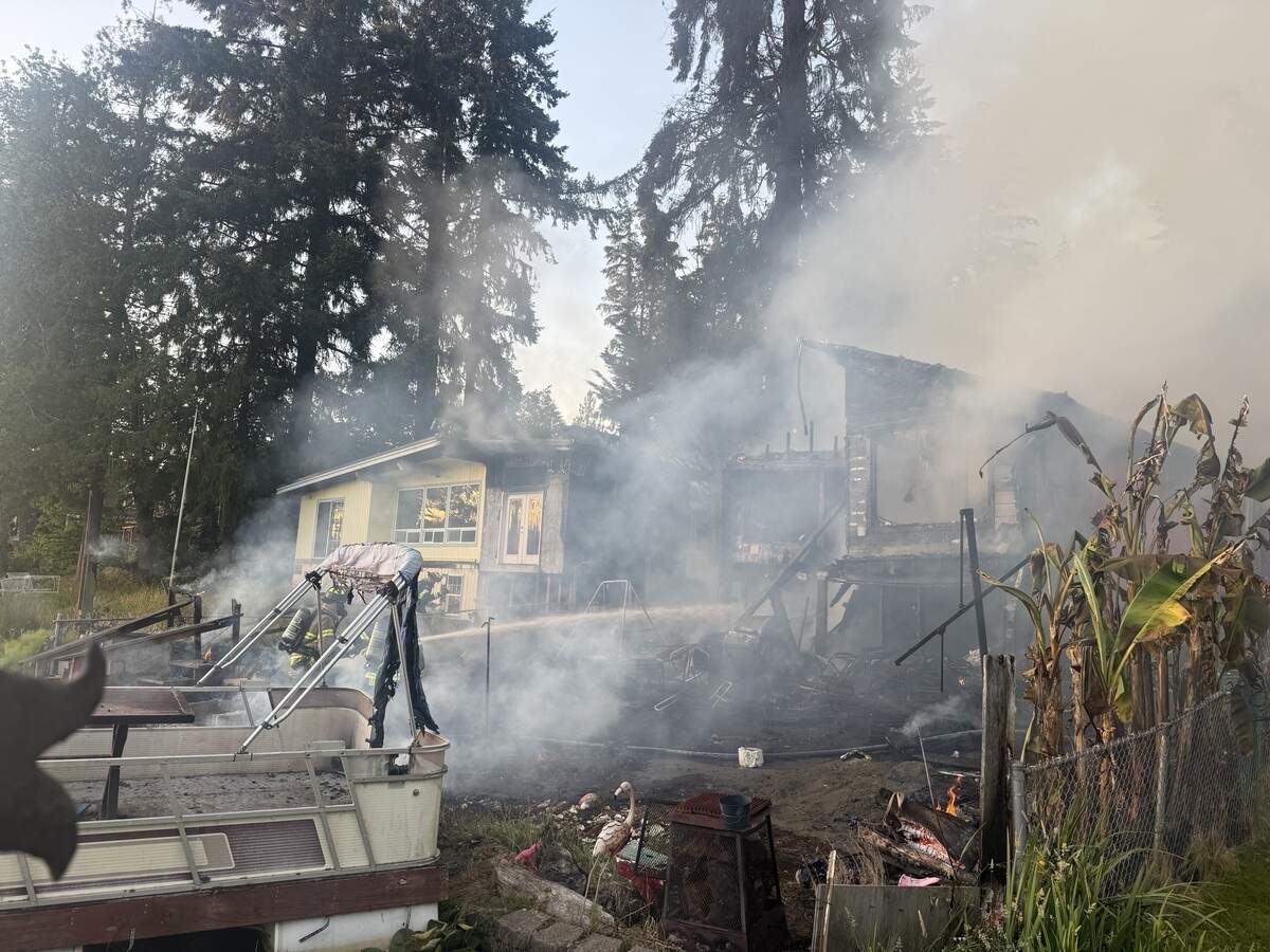 Units with Lacey Fire District 3 responded to a house fire on Pattison Lake on Sunday evening that spread to a tree and a neighbor’s home.