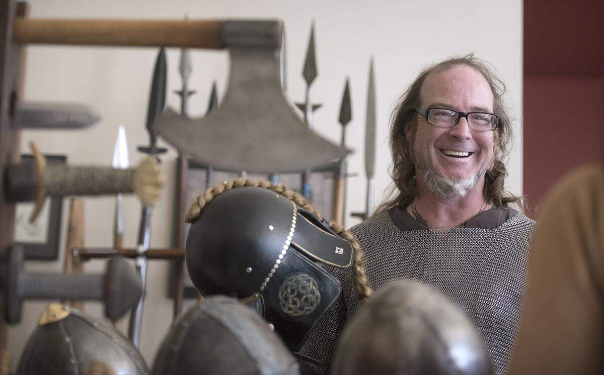 William Koutrouba of Scarlet Arts Design stops by the Vikings North West booth during the 2016 Olympia Norway Day celebration at the Thurston County Fairgrounds in Lacey.