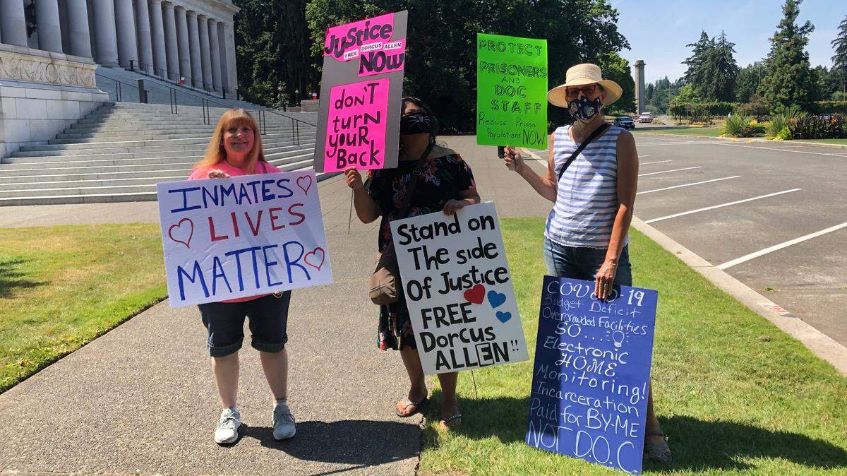 Julie Modun (left) and Norren Leit (right) stand with another protester they met outside of the state Legislative Building during a July 31 rally.