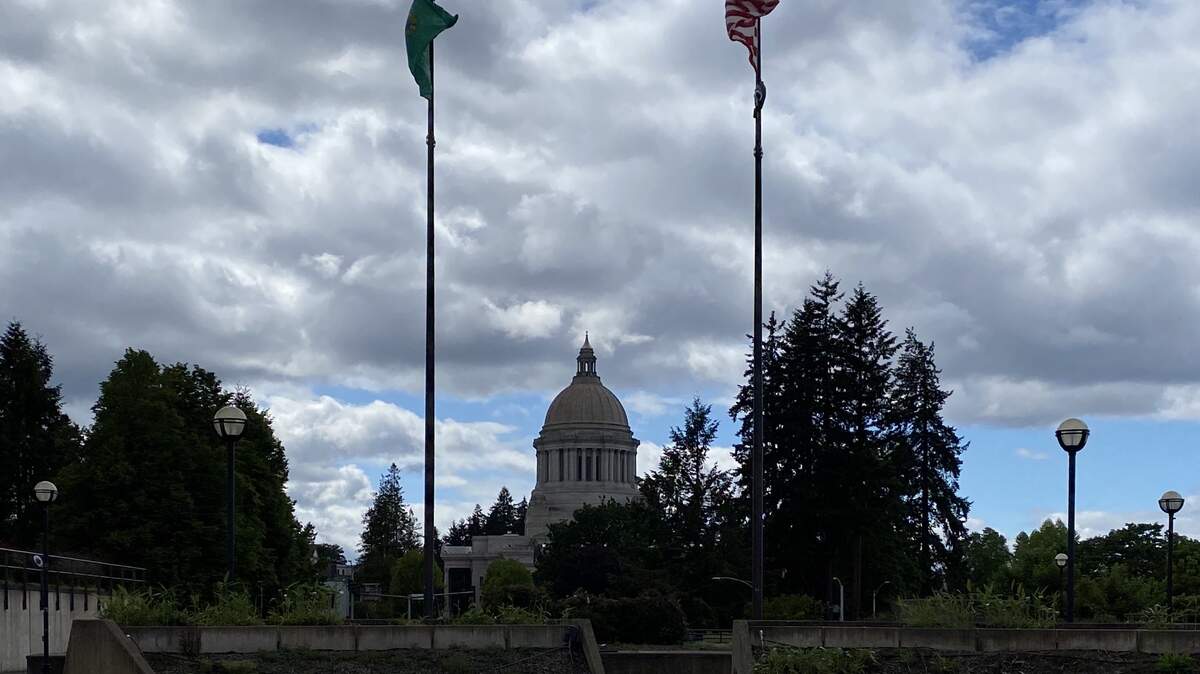 Winds blow the flags on the East Capitol Campus Wednesday. Cloudy skies are likely to be a fixture this holiday weekend.