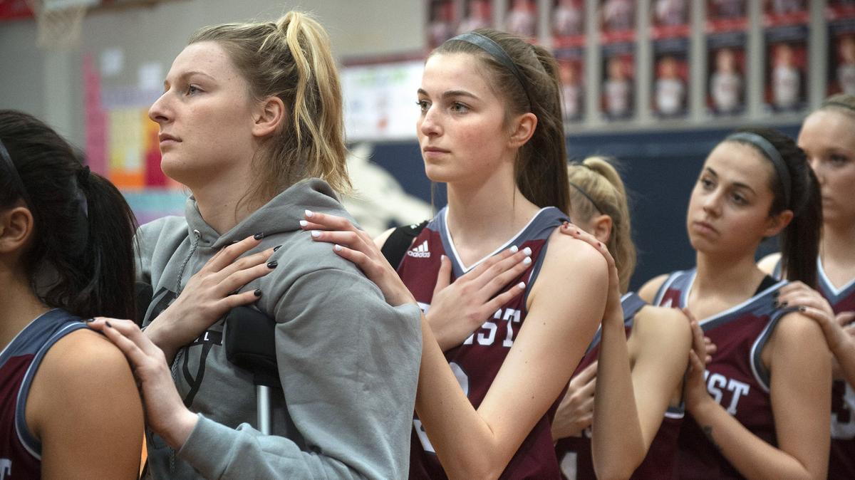 W.F. West freshman guard Drea Brumfield (center) had one season to play basketball with her big sister, senior Erika Brumfield (left) in 2018-19, until Erika injured her knee. But they still are side-by-side, shown before a girls basketball game at Black Hills High School in Tumwater on Jan. 16, 2019.