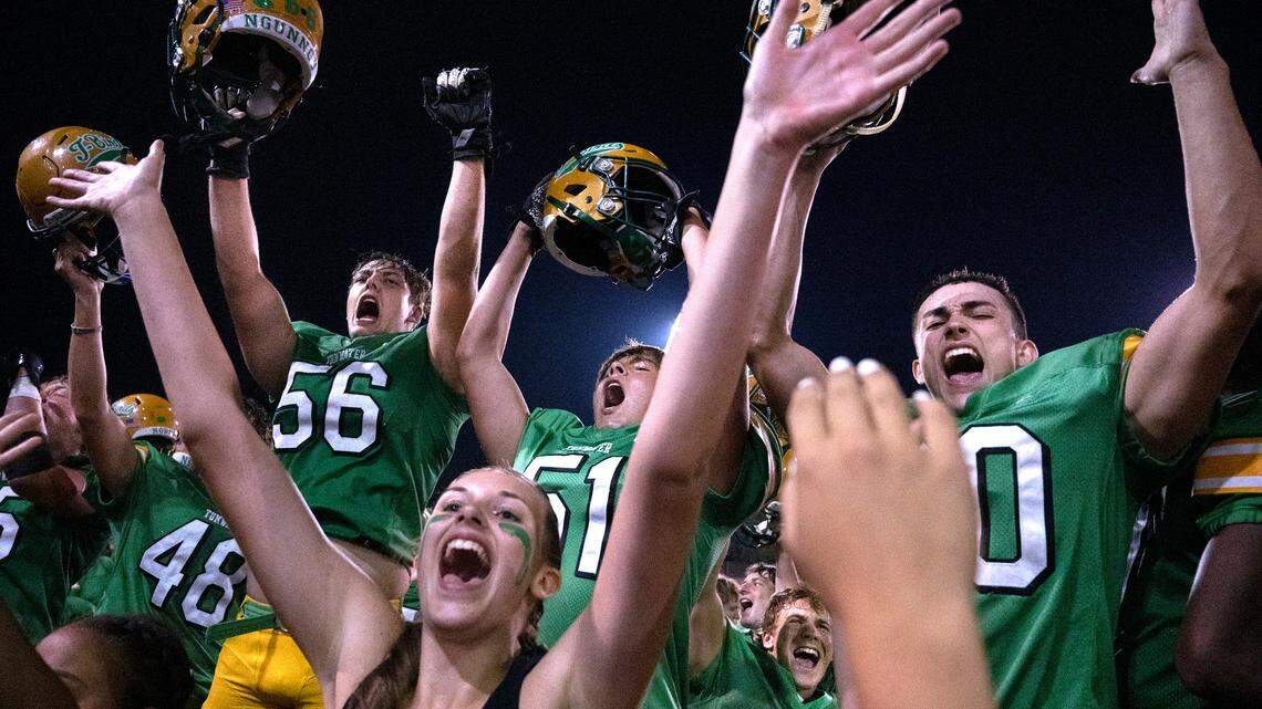 Tumwater players Brayden Weiks (48), Alexander Hach (56), Alec Cruz (51), Mikah Sederberg (33) and Kai MLeod (20) celebrate with the cheerleaders following the T-Birds’ 8-6 victory over the North Kitsap Vikings during Friday night’s 2A football game at Tumwater District Stadium in Tumwater, Washington, on Sept. 9, 2022.