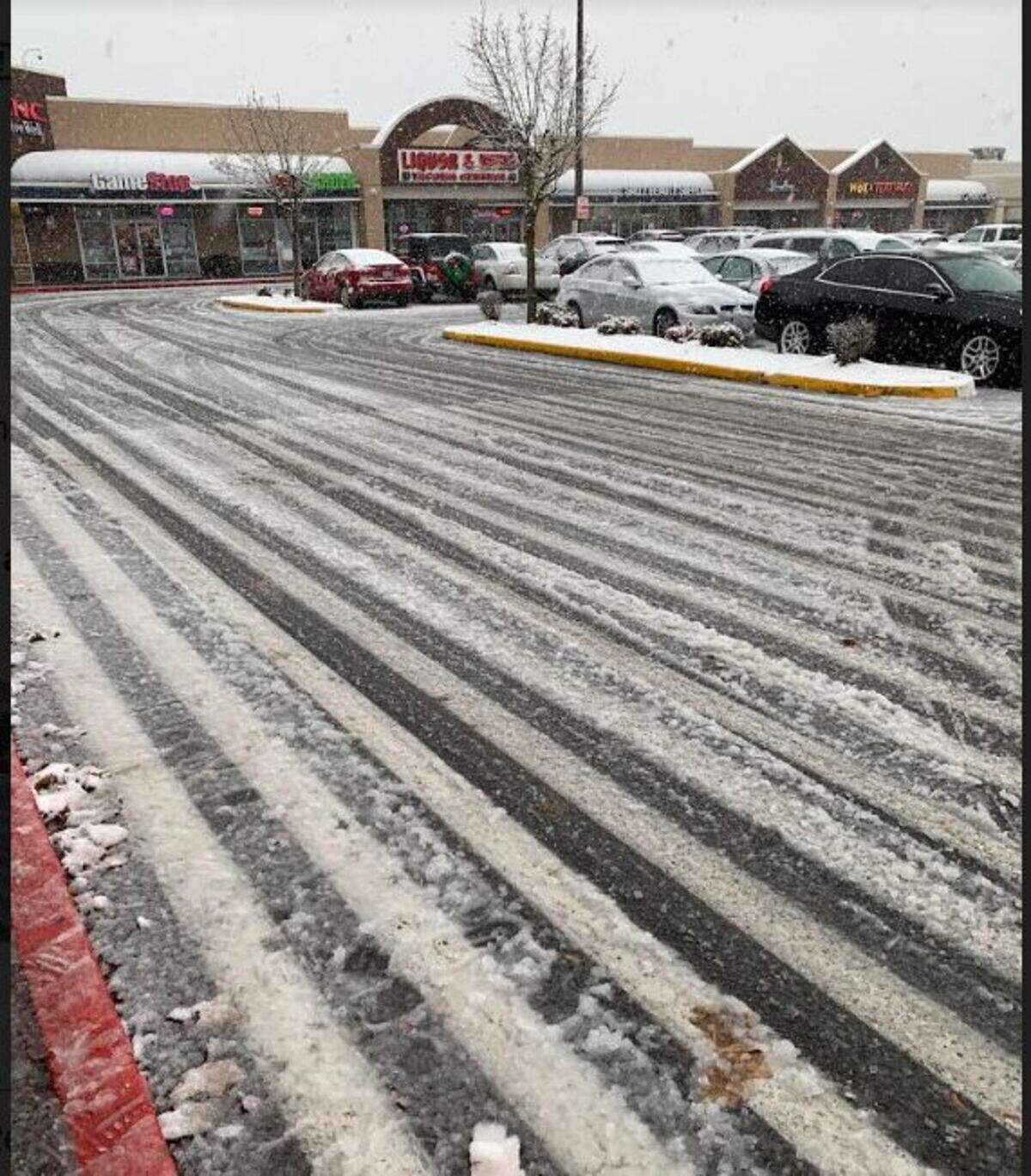 Snow began accumulating Sunday at a shopping center off state Route 16.